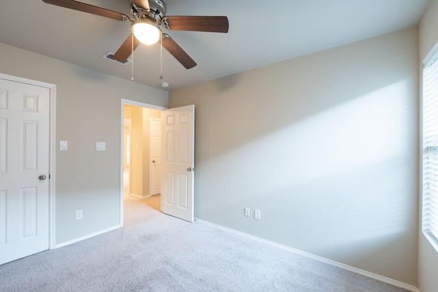 unfurnished bedroom featuring ceiling fan and light colored carpet