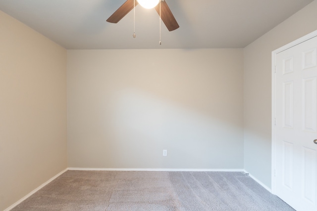 carpeted spare room with ceiling fan