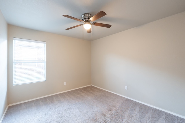 empty room with ceiling fan and carpet