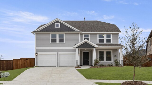 craftsman-style house featuring a garage and a front yard