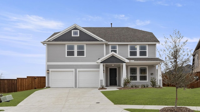 view of front of property featuring a garage, fence, driveway, roof with shingles, and a front lawn