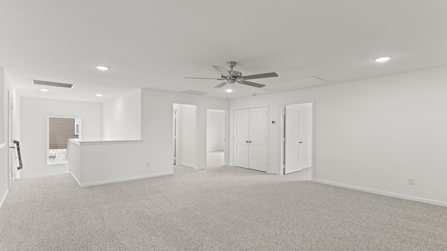 unfurnished room with light carpet, recessed lighting, visible vents, and attic access