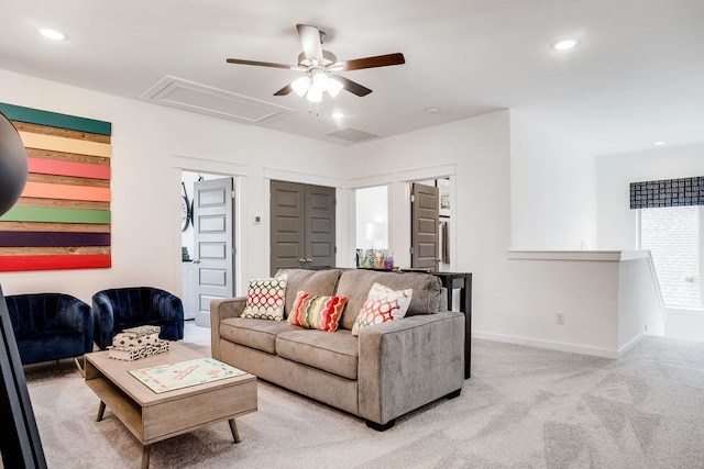 carpeted living room with ceiling fan