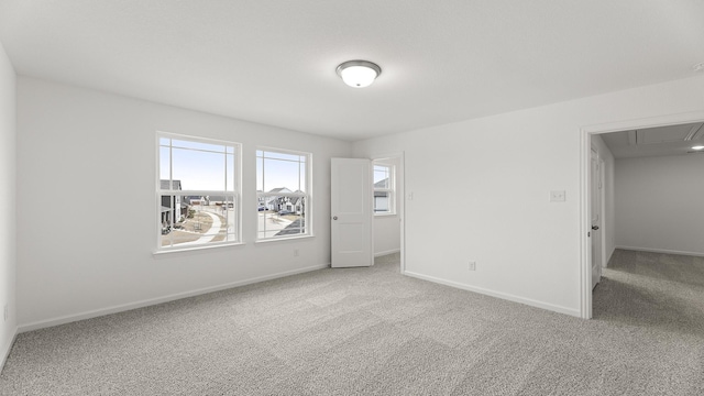 unfurnished room with carpet and baseboards