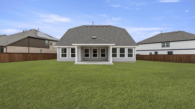 back of house featuring a yard, a fenced backyard, and a patio