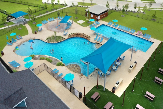 community pool featuring a patio area and fence