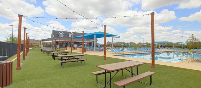 view of home's community featuring a lawn and a pool