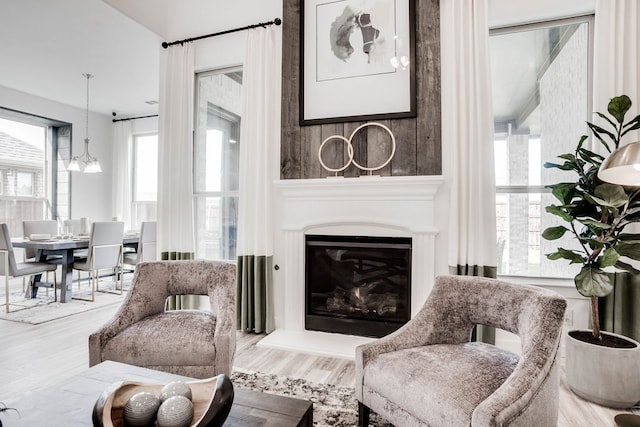 living room featuring wood-type flooring and an inviting chandelier