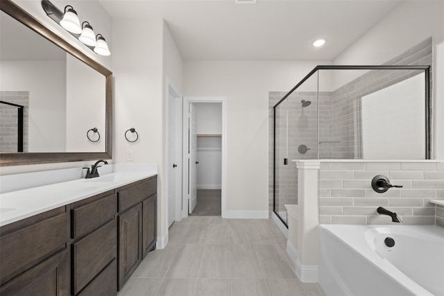 bathroom featuring tile patterned floors, independent shower and bath, and vanity