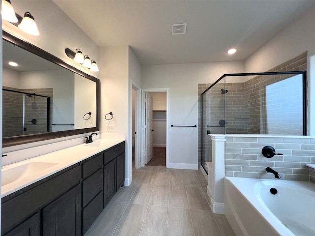 bathroom featuring tile patterned flooring, vanity, and plus walk in shower