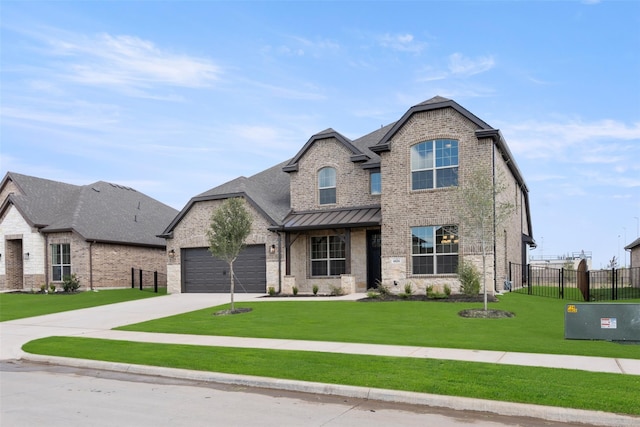 french provincial home featuring a front yard and a garage