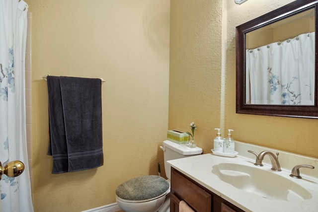 bathroom featuring toilet and vanity