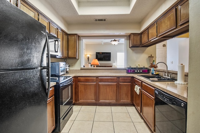 kitchen with sink, black appliances, light tile patterned floors, a textured ceiling, and ceiling fan