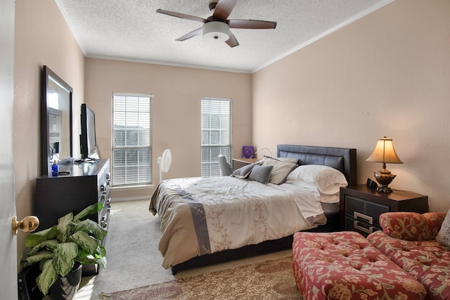 bedroom with crown molding, light colored carpet, a textured ceiling, and ceiling fan