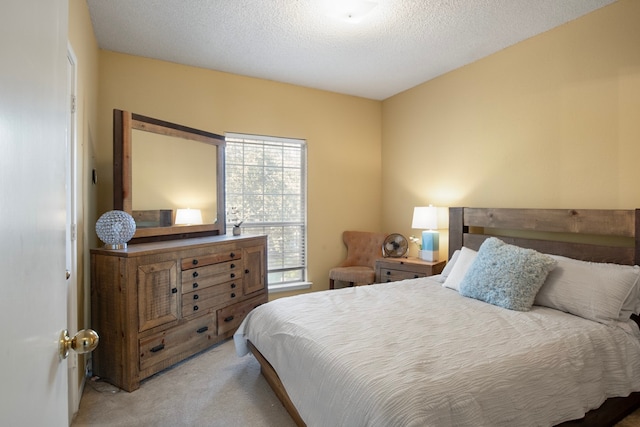 carpeted bedroom featuring a textured ceiling