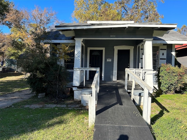 exterior space featuring a lawn and a porch