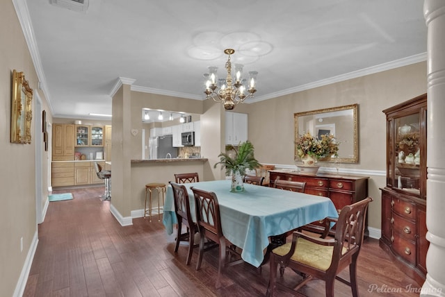 dining area with ornamental molding, a chandelier, and dark hardwood / wood-style flooring