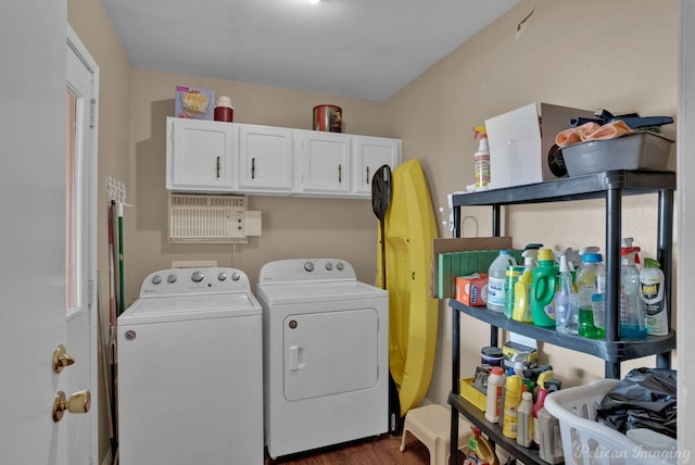 laundry area featuring washing machine and dryer, dark hardwood / wood-style flooring, and cabinets