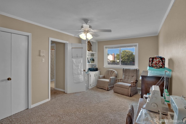 sitting room featuring light carpet, ceiling fan, and crown molding