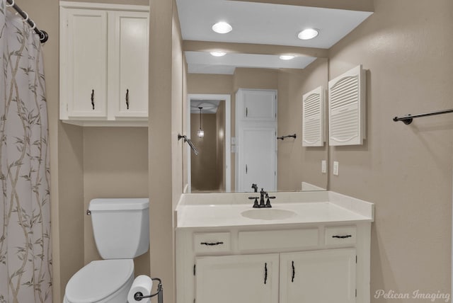 bathroom with walk in shower, vanity, and toilet