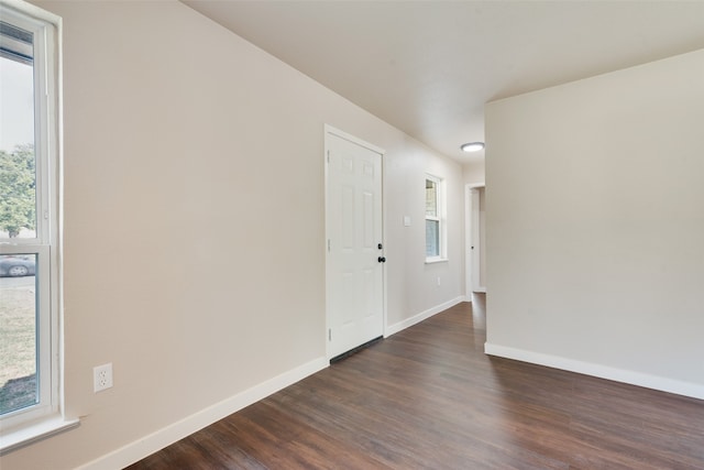 empty room with dark hardwood / wood-style floors