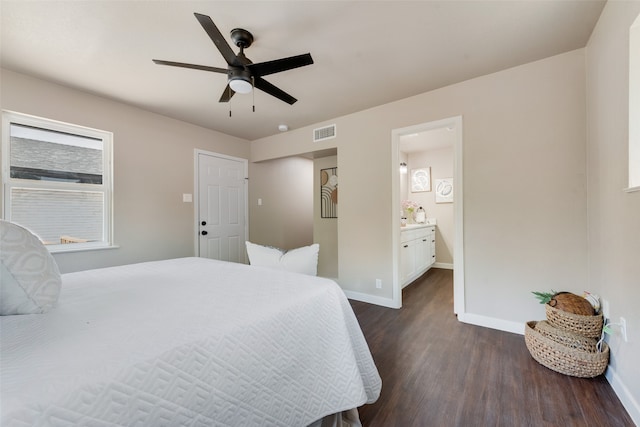 bedroom featuring connected bathroom, dark hardwood / wood-style floors, and ceiling fan