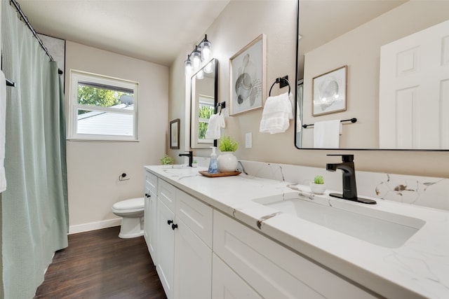 bathroom featuring hardwood / wood-style floors, vanity, and toilet