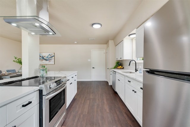 kitchen with white cabinets, dark wood-type flooring, exhaust hood, appliances with stainless steel finishes, and light stone countertops