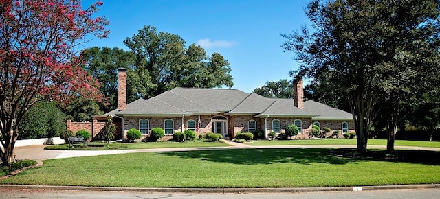 ranch-style home with a front lawn