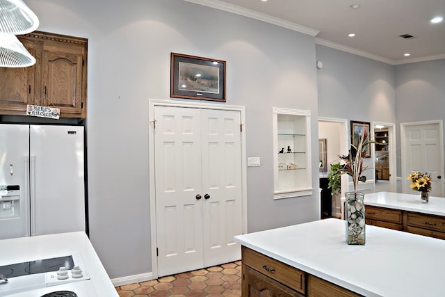 interior space featuring ornamental molding, tile patterned flooring, and white refrigerator with ice dispenser