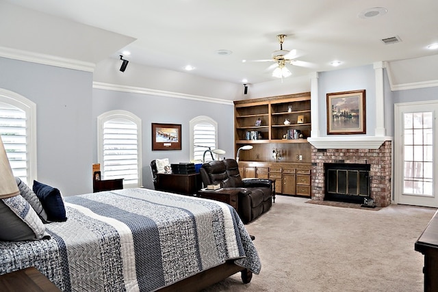 carpeted bedroom featuring ceiling fan, a fireplace, crown molding, and multiple windows