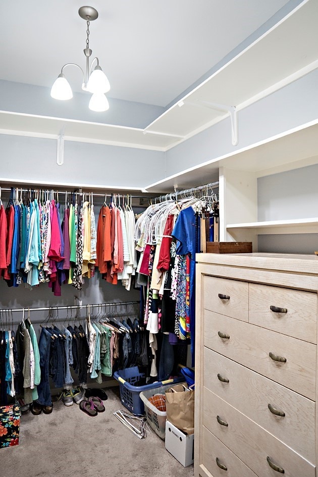 spacious closet with carpet flooring and a notable chandelier