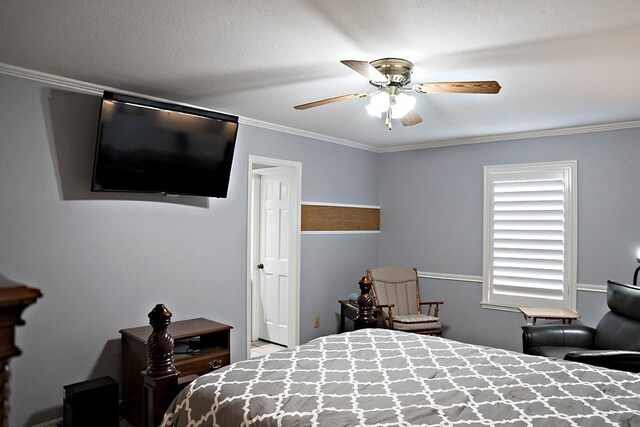 bedroom with ceiling fan and crown molding