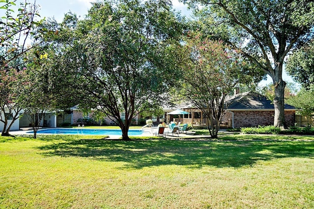 view of yard featuring a fenced in pool and a patio area