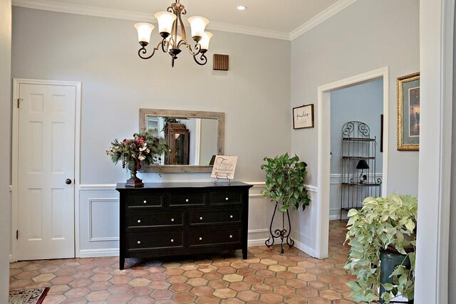 interior space with ornamental molding, a towering ceiling, and a chandelier