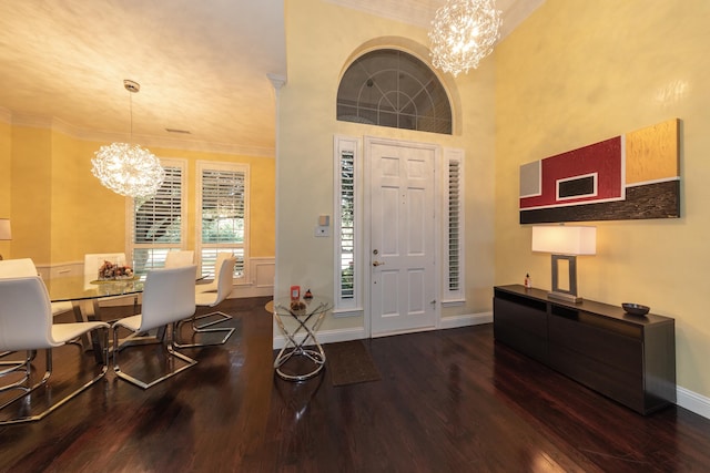 living room featuring a towering ceiling, dark hardwood / wood-style floors, and crown molding