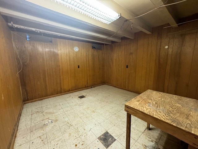 basement featuring wooden walls