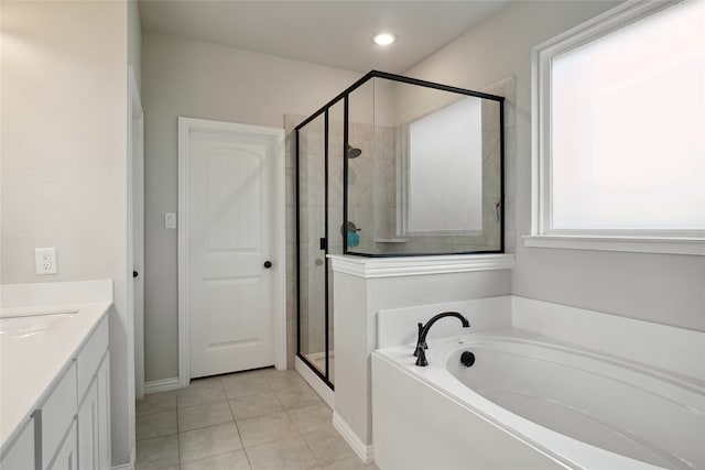 bathroom featuring independent shower and bath, vanity, and tile patterned floors