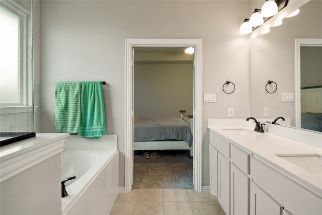 bathroom with tile patterned floors, vanity, and a bathtub