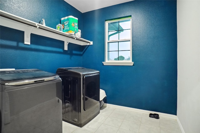 clothes washing area featuring separate washer and dryer and light tile patterned flooring