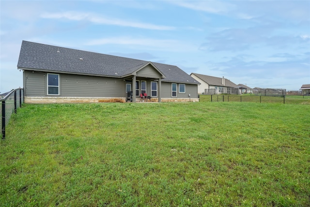 rear view of house with a yard