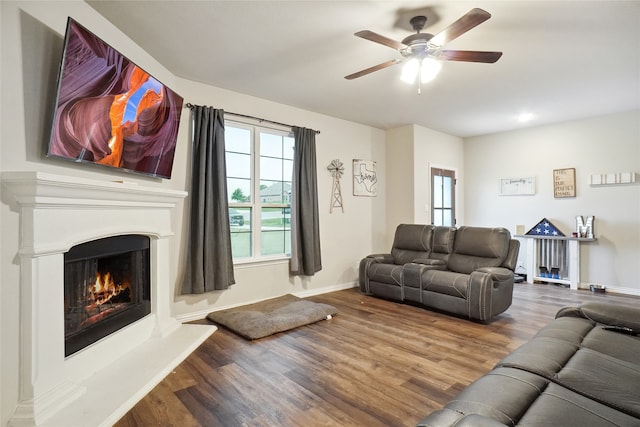 living room featuring wood-type flooring and ceiling fan