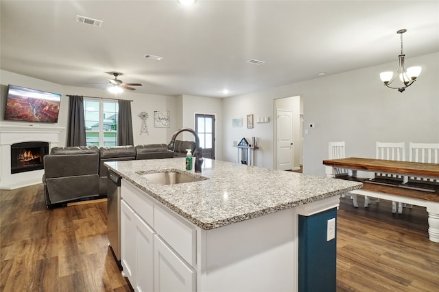 kitchen featuring hanging light fixtures, sink, a kitchen island with sink, ceiling fan with notable chandelier, and dark hardwood / wood-style flooring