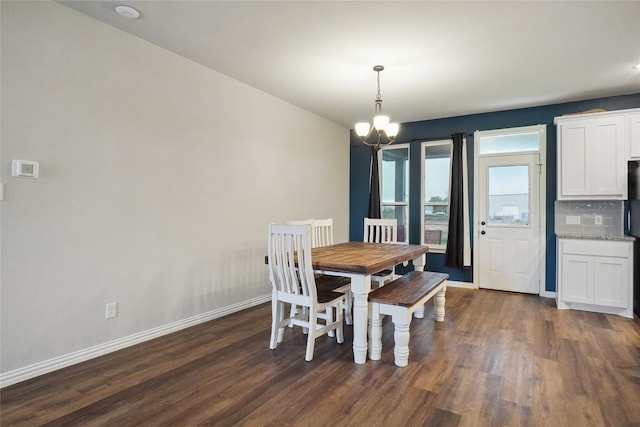 dining room featuring an inviting chandelier and dark hardwood / wood-style floors