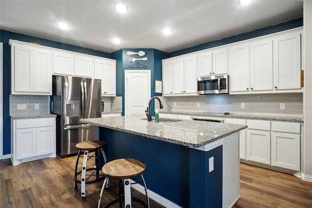 kitchen featuring dark wood-type flooring, stainless steel appliances, and white cabinets