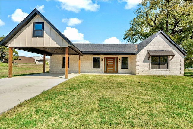 306 Sunset, Roxton, TX 75477 - view of front of house with brick siding, board and batten siding, roof with shingles, and a front lawn
