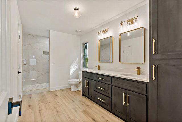 bathroom with vanity, hardwood / wood-style flooring, an enclosed shower, and toilet