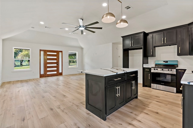 kitchen with light wood-type flooring, stainless steel range oven, and a healthy amount of sunlight