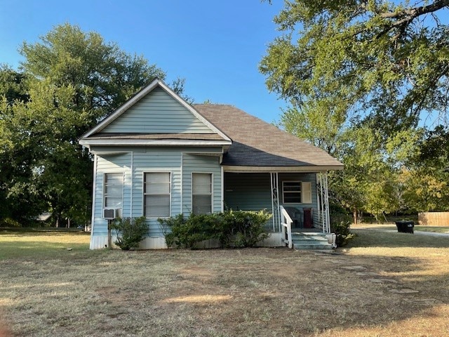 bungalow-style house featuring cooling unit and a porch