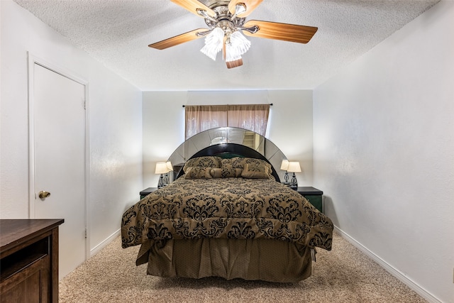 bedroom featuring ceiling fan, a textured ceiling, and carpet flooring